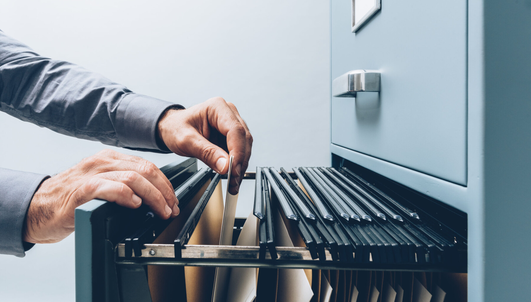 Office,Clerk,Searching,For,Files,Into,A,Filing,Cabinet,Drawer Office,Clerk,Searching,For,Files,Into,A,Filing,Cabinet,Drawer