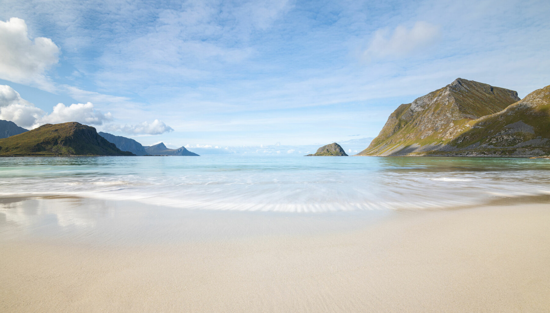 Panorama of scenic Haukland beach on Lofoten Islands in Norway on a bright summer day