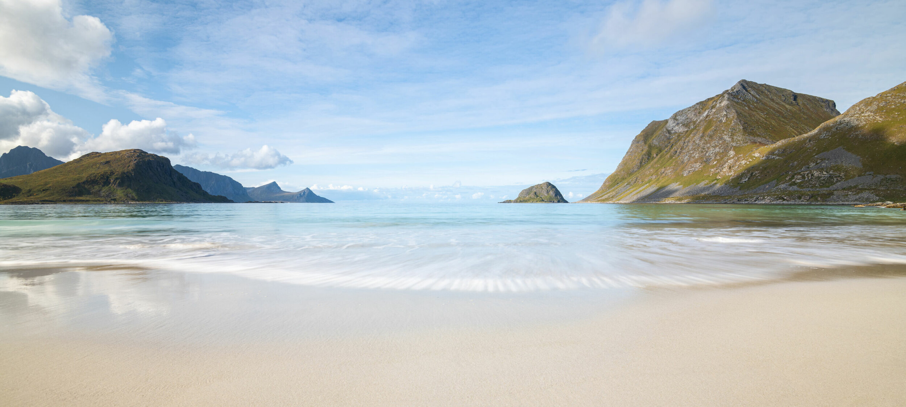 Panorama of scenic Haukland beach on Lofoten Islands in Norway on a bright summer day